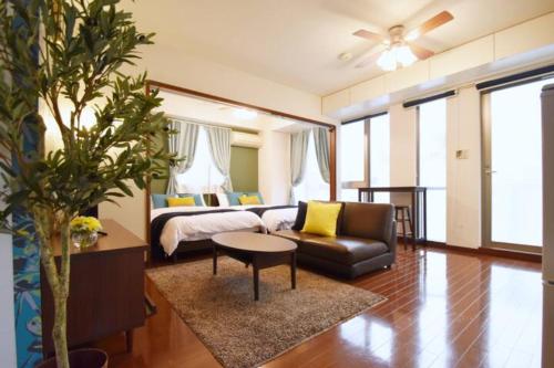 - une chambre avec un lit, un canapé et une table dans l'établissement レガリアヒルズ, à Tokyo