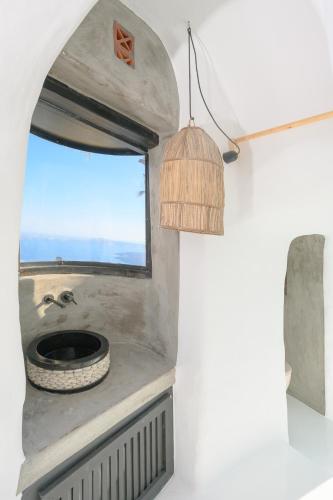 a bathroom with a sink and a window at Sophia Luxury Suites in Imerovigli