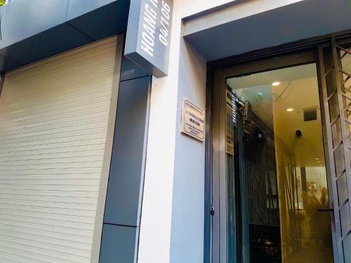 a door to a store with a sign on it at Unique Serviced Apartment in Hanoi