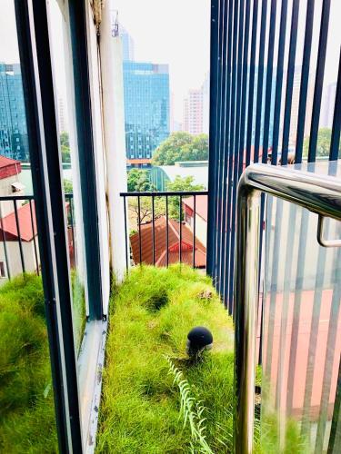 a balcony with grass on the floor of a building at Unique Serviced Apartment in Hanoi