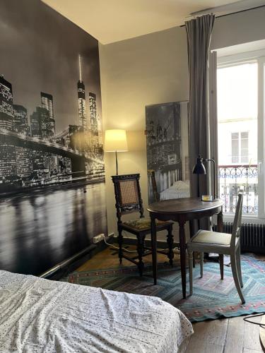 a bedroom with a desk and a table and a bed at Cosy Nest in Montmartre in Paris