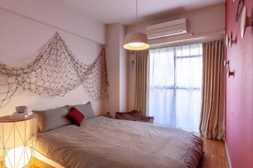 a bedroom with a bed and a large window at Chatelet Nishioi in Tokyo