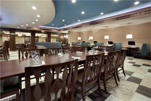 a dining room with tables and chairs in a restaurant at Holiday Inn Hotel & Suites Northwest San Antonio by IHG in San Antonio