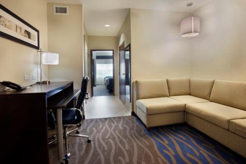 a living room with a couch and a desk at Holiday Inn Hotel & Suites Northwest San Antonio by IHG in San Antonio