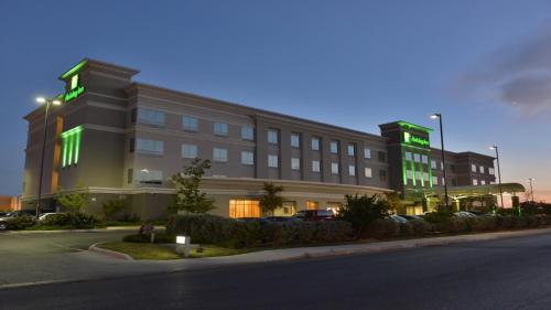 a building with green lights on the side of it at Holiday Inn Hotel & Suites Northwest San Antonio by IHG in San Antonio