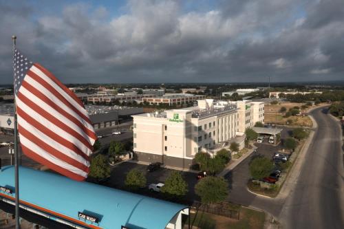 an american flag flying on top of a building at Holiday Inn Hotel & Suites Northwest San Antonio by IHG in San Antonio