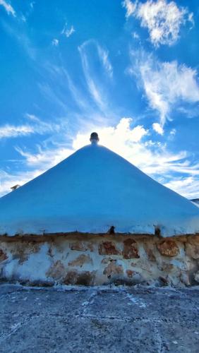 a large white tent with a blue sky at Trullo Donna Caterina in Ceglie Messapica