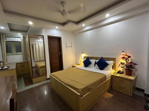 a bedroom with a large bed and a bathroom at Hotel DH in Dharamshala