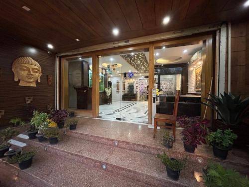 a front door of a building with potted plants at Hotel DH in Dharamshala