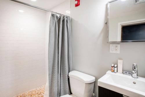 a bathroom with a shower and a toilet and a sink at Downtown Studio w AC nr N Station TD Garden BOS-211 in Boston