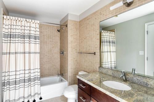 a bathroom with a sink and a tub and a toilet at Foggy Bottom 1br w wd pool gym nr Georgetown WDC-652 in Washington
