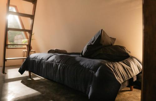 a bed with black sheets and pillows in a room at Ranasa Yogyakarta in Timuran