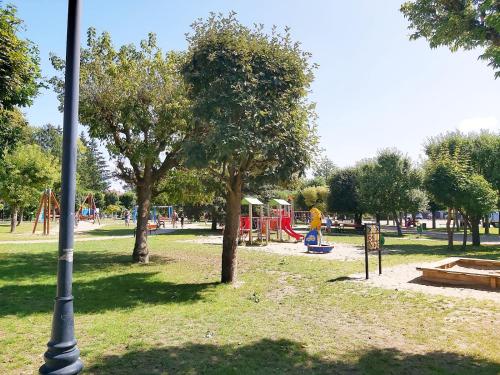 a park with a playground and a pole in the grass at Apartament Parkowa 2 in Morąg