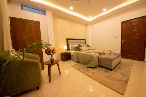 a bedroom with a bed and a couch and a chair at Perfectstayz Value Homes Mussoorie 120 meters uphill in Mussoorie