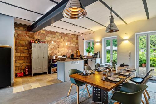 a kitchen and dining room with a table and chairs at Gutshof Kaiserbacher Mühle in Klingenmünster