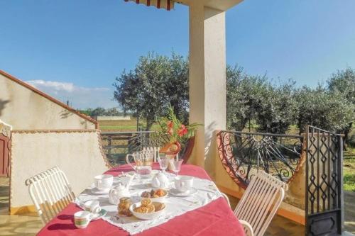 a table with a plate of food on a porch at Villa in campagna vicina al mare Bonerelax in Menfi