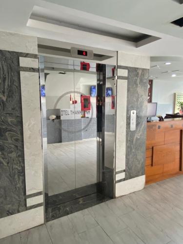a lobby with a glass door in a building at Khách sạn Thanh Bình 3 in Ho Chi Minh City