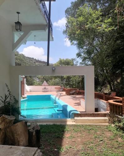 a swimming pool in a yard with a swimming pool at LU'UM Master Suites in Taxco de Alarcón