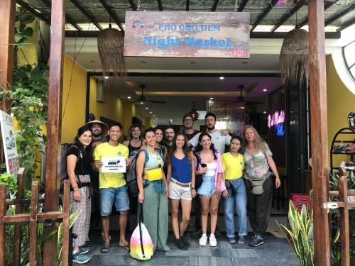 a group of people standing in front of a building at PHỐ CHỢ ĐÊM Villa - Near Hoi An Old Town 200m in Hoi An