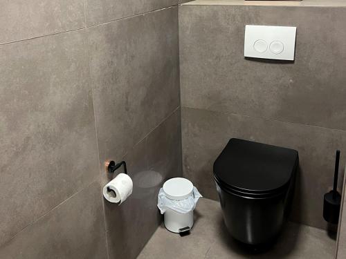 a bathroom with a toilet and a trash can at Apartment Wesseling in Wesseling