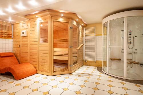 a large bathroom with a shower and a bench in it at Ferienwohnung Zur Imme in Lindau