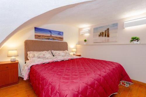 a bedroom with a large pink bed in an attic at Sicily Loft Catania few min from sea - Happy Rentals in Catania