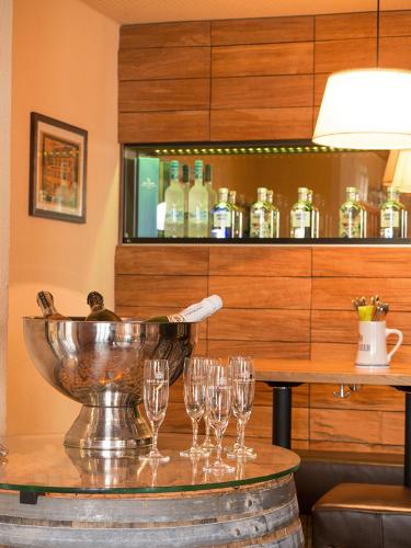a group of wine glasses on a table in a restaurant at Gasthof Deutscher Adler und Hotel Puchtler in Bischofsgrün