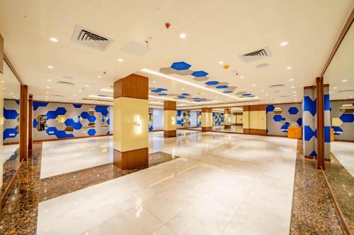 a large lobby with blue and white walls at Payel Inn in Āsansol