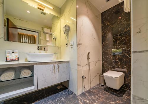 a bathroom with a toilet and a shower at Payel Inn in Āsansol
