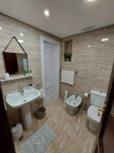 a bathroom with a sink and a toilet at Apartamentos Florida Casablanca in Vigo