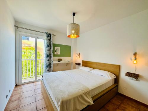 Un dormitorio con una cama grande y una ventana en Casa Adele terraza del mar, en Corralejo