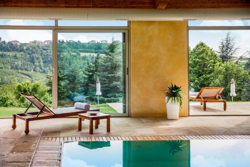 a house with a pool and a view of the mountains at Relais Montemarino in Borgomale