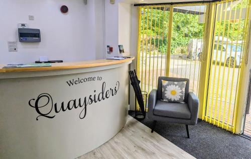 an office with a welcome desk and a chair at Quaysiders Club in Ambleside