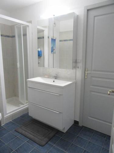 une salle de bain blanche avec un lavabo et une douche dans l'établissement Nice Appt In Briançon Les Charmettes, à Briançon