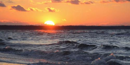 un tramonto sulla spiaggia con l'oceano di Ferienwohnung Mercedes a Zinnowitz