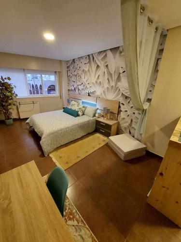 a large bedroom with a bed and a wall with aigunigunigun at La Ruta de las luces de Vigo in Vigo