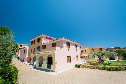 a view of a house with a brick driveway at ISA - Residence with swimming pool in Sos Alinos, apartments with air conditioning and private outdoor area in Cala Liberotto