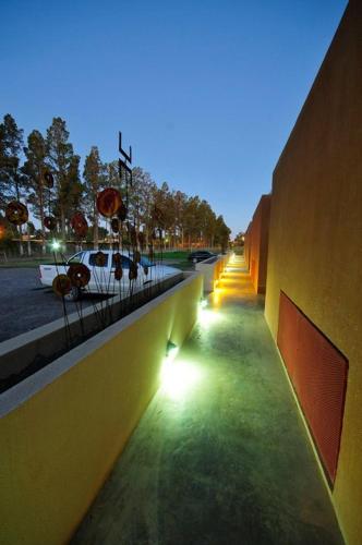 a sidewalk with lights on the side of a building at Herradura Hotel Suites in Neuquén