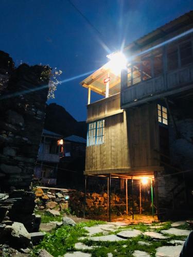 a building with a light on top of it at night at Ela in Ushguli