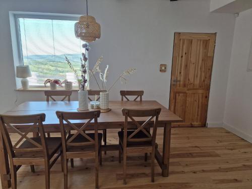 a dining room with a wooden table and chairs at Villa Lindenberg Slovakia in Krupina