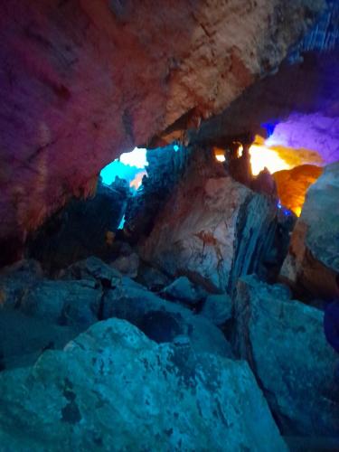 a cave with some rocks and lights in it at Khách sạn Vườn Quốc gia Ba Bể in Bak Kan