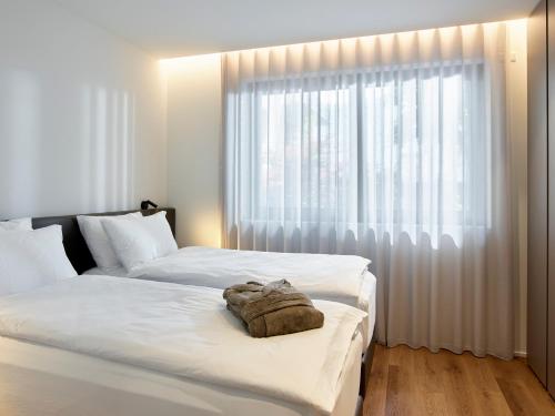 a bedroom with two beds and a large window at Civico 65 Garda Holiday 03 in Arco