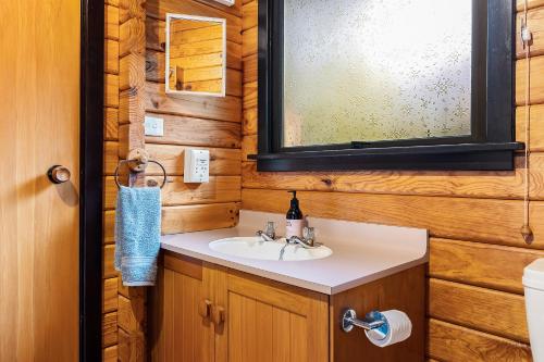 a bathroom with a sink and a mirror at Hanmer Hideaway in Hanmer Springs