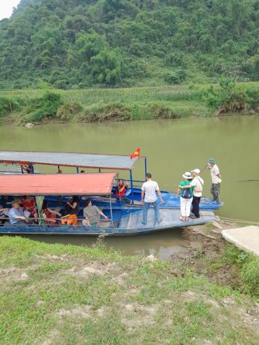 a group of people on a boat on a river at Khách sạn Vườn Quốc gia Ba Bể in Bak Kan