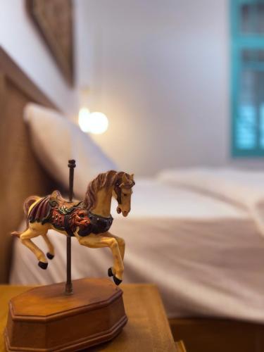 a toy horse on a table in a bedroom at Talpiot Oasis-Louis in Haifa