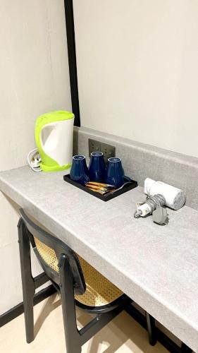 a table with blue cups on top of it at C Hotel in Jitra