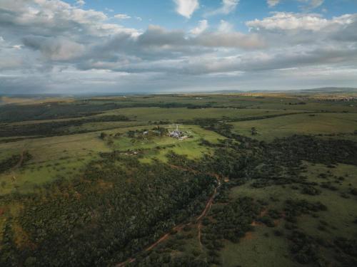 an aerial view of a house in the middle of a field at Umbono Private Game Lodge in Alexandria