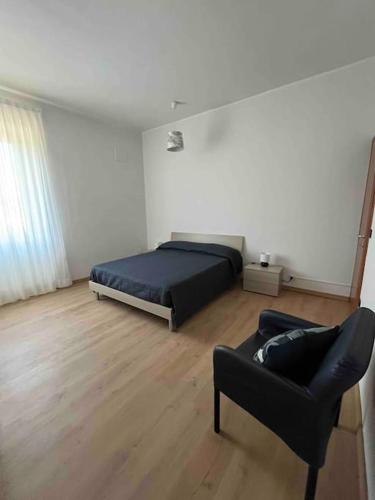 a bedroom with a bed and a chair and a couch at Appartamento Casa Armonia a Montefiascone in Montefiascone