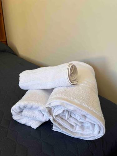 a pile of towels sitting on top of a bed at Appartamento Casa Armonia a Montefiascone in Montefiascone