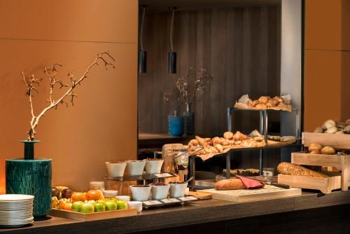 a buffet with different types of food on a table at Adina Apartment Hotel Frankfurt Westend in Frankfurt/Main